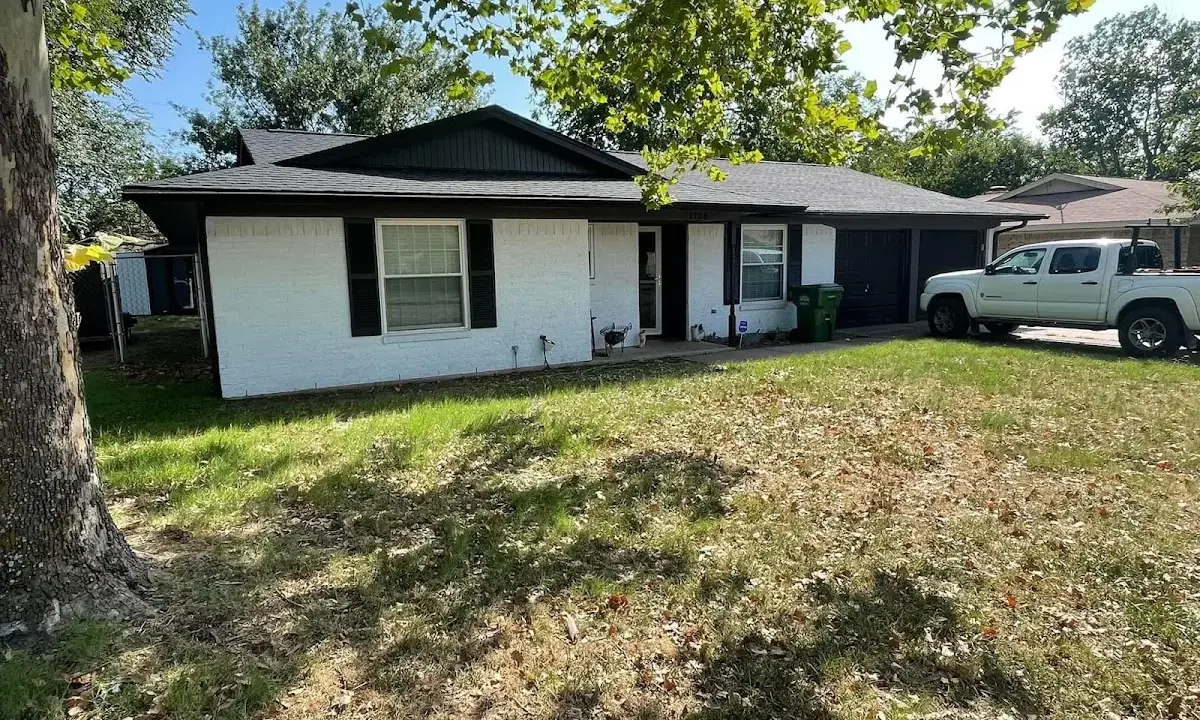 Professional roofing crew working on a residential roof in Firestone